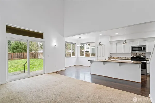 a kitchen with stainless steel appliances granite countertop a stove and a refrigerator