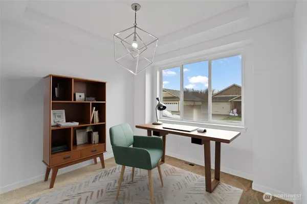 a view of a room with a table and chairs
