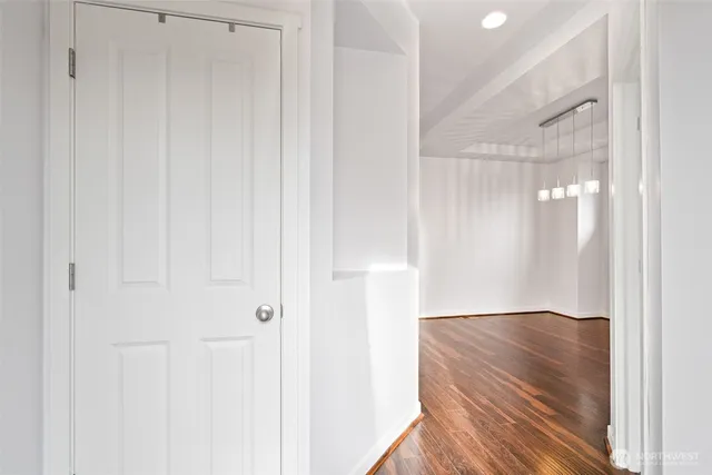 a kitchen with stainless steel appliances granite countertop a sink a stove and a wooden floors