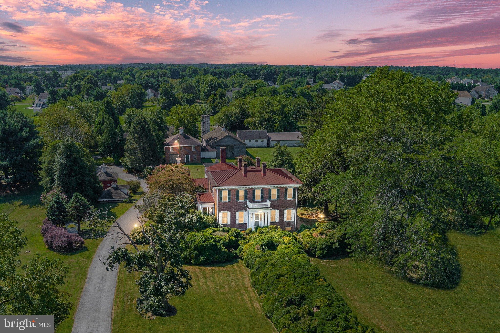 a view of a garden with a building in the background