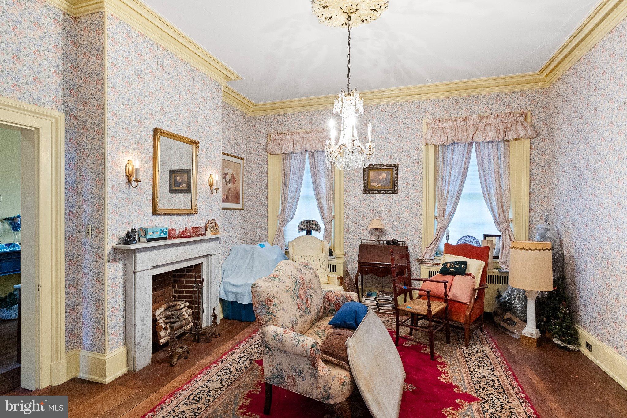 692 Bayview Road Middletown, DE 19709 - Photo 25 of 37 a living room with furniture a chandelier and a fireplace