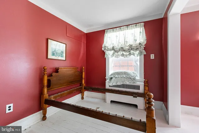 a bedroom with furniture and a window