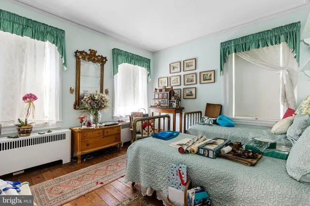 a bedroom with furniture toys and a large window