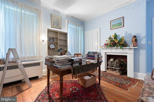 a living room with furniture a fireplace and a table