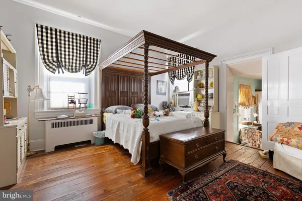 a bedroom with a bed and a fireplace