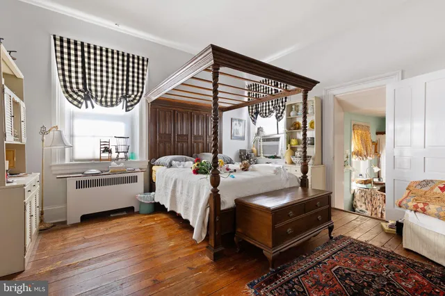 a bedroom with a bed and a fireplace