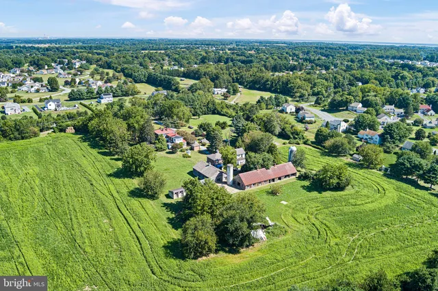 a view of a garden with a building in the background