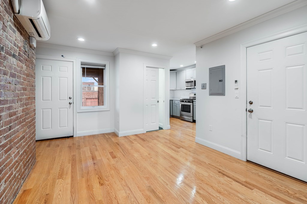 14 Pompeii Street, Unit 2 Boston, MA 02119 - Photo 1 of 11 a view of empty room with wooden floor and kitchen