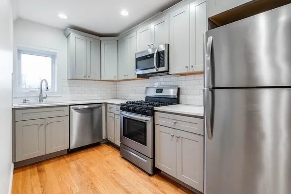 a kitchen with a refrigerator sink and microwave