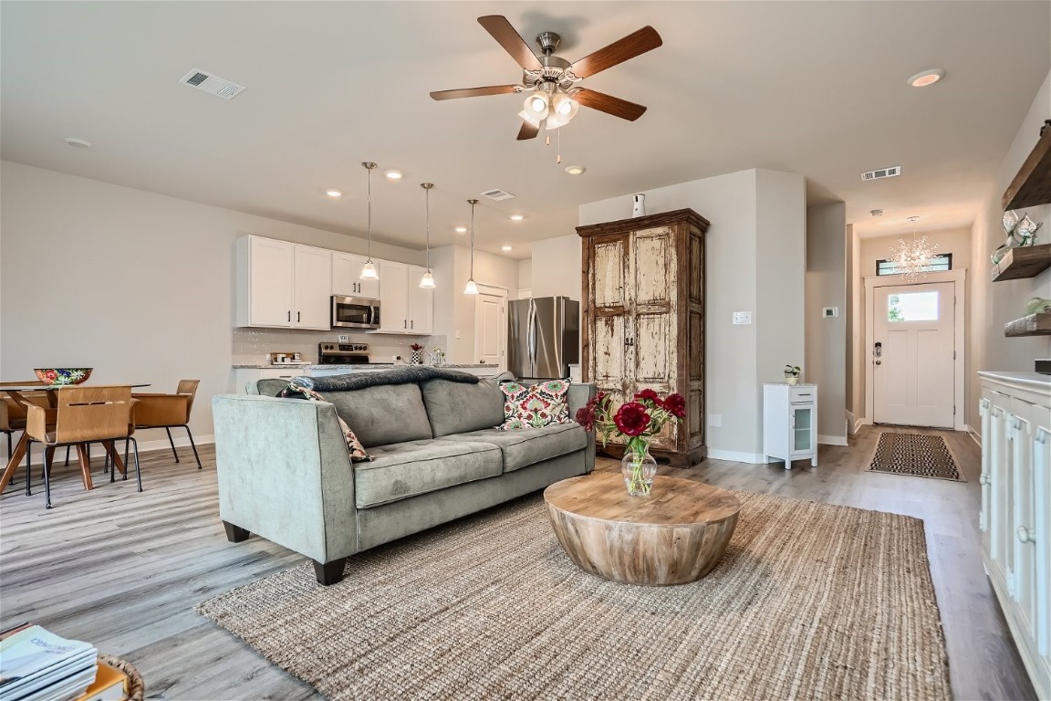 164 B Threshing Road, Unit B Buda, TX 78610 - Photo 1 of 1 a living room with furniture and a chandelier