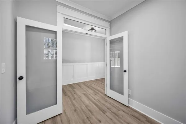a large kitchen with stainless steel appliances granite countertop a large stove a sink dishwasher and white cabinets with wooden floor
