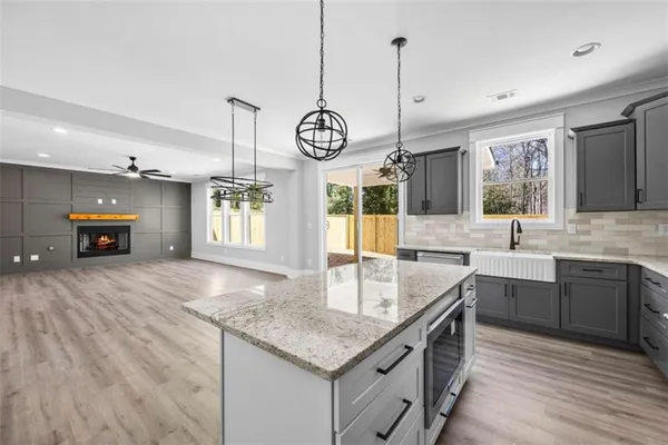 an empty room with window and ceiling fan