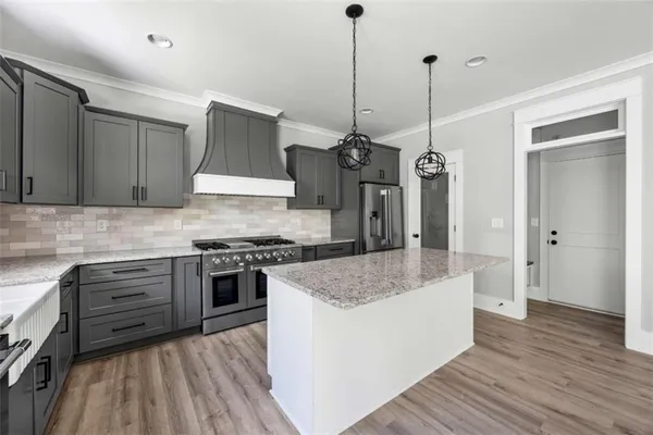 a bathroom with a granite countertop double vanity sink and mirror