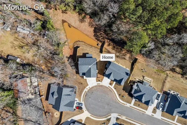 an aerial view of a backyard with fountain and barbeque oven