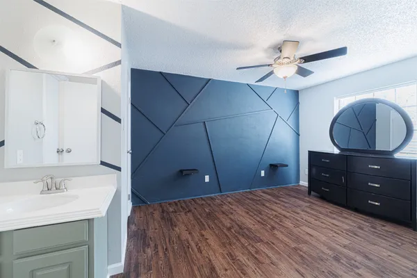 a bedroom with a bed and a dresser
