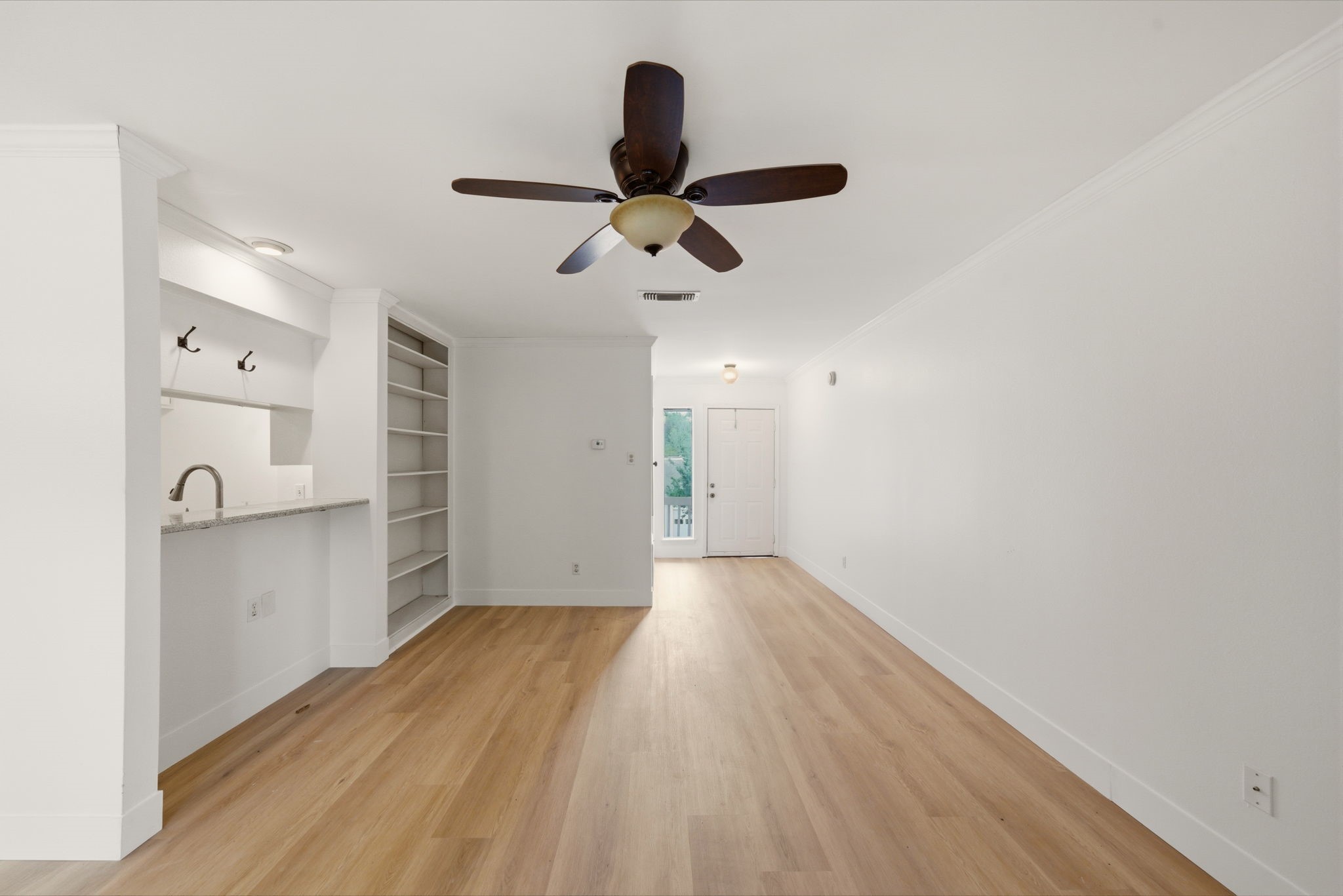 3 Hideaway Drive Friendswood, TX 77546 - Photo 4 of 15 a view of empty room with wooden floor and ceiling fan