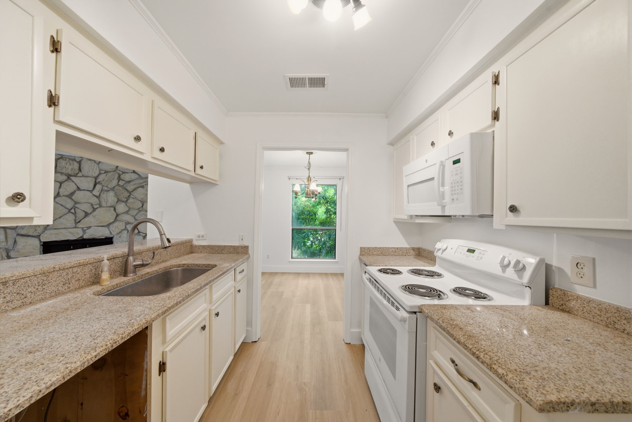 3 Hideaway Drive Friendswood, TX 77546 - Photo 6 of 15 a kitchen that has a sink a stove and a window