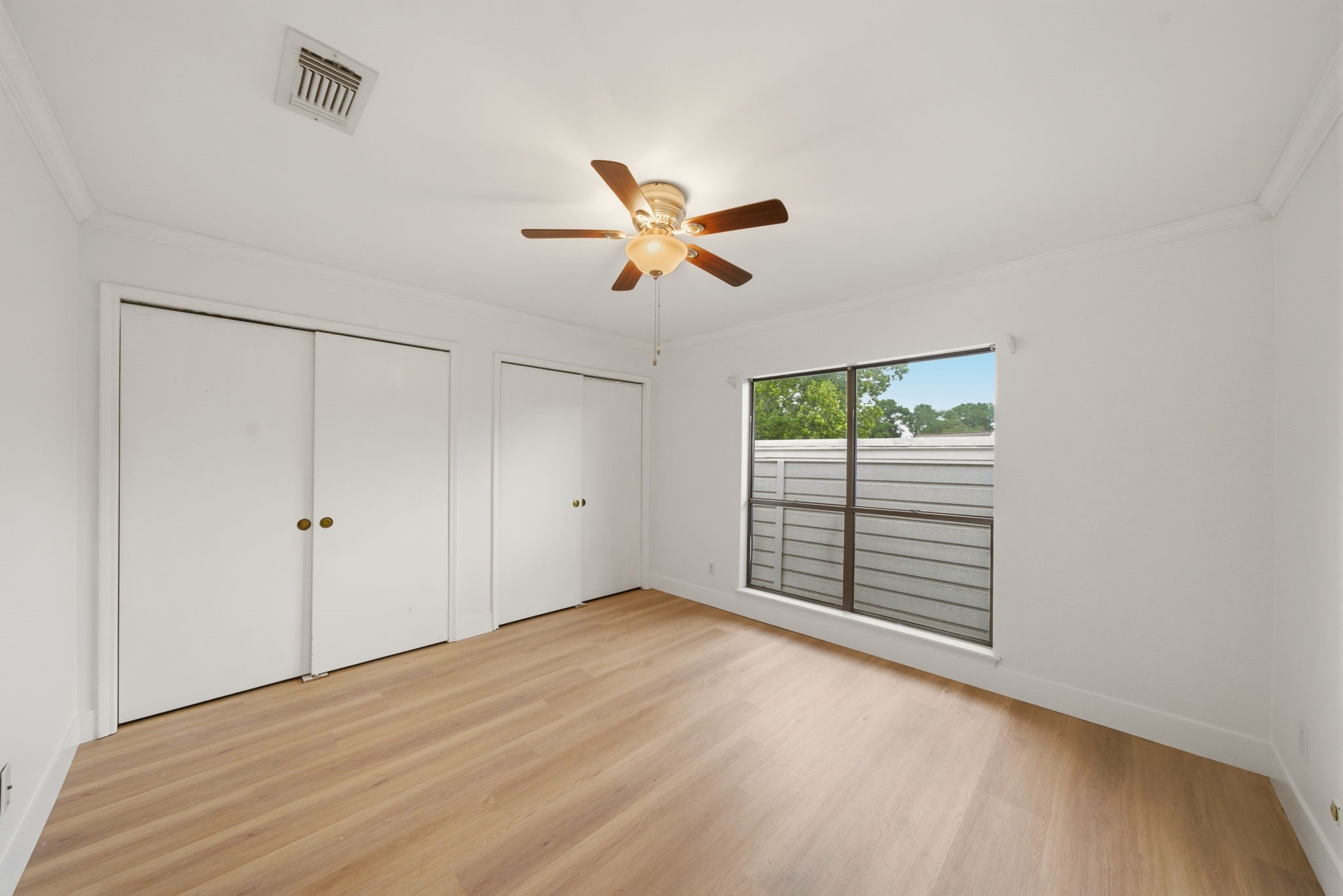 3 Hideaway Drive Friendswood, TX 77546 - Photo 9 of 15 a view of a room with a ceiling fan and a window