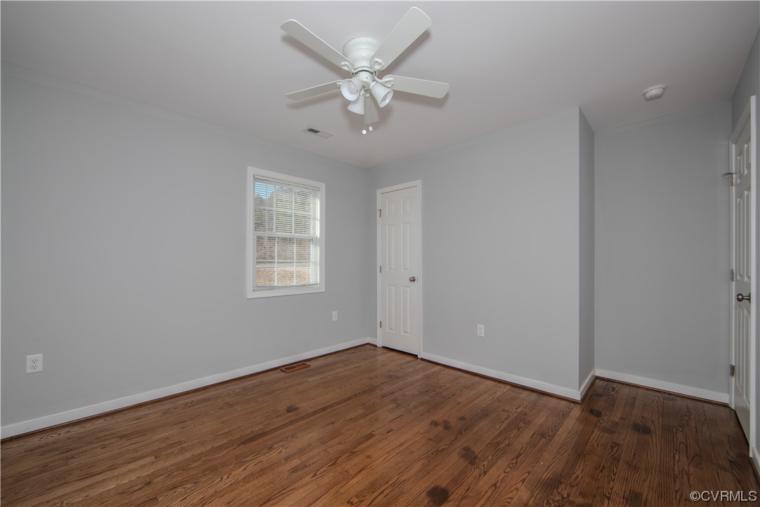1001 Red House Road Ford, VA 23850 - Photo 12 of 20 a view of an empty room with wooden floor and a ceiling fan