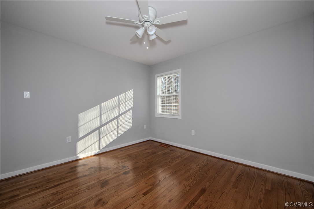 1001 Red House Road Ford, VA 23850 - Photo 13 of 20 an empty room with wooden floor chandelier fan and windows