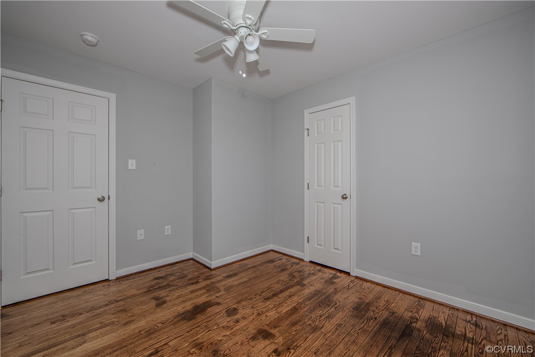1001 Red House Road Ford, VA 23850 - Photo 15 of 20 an empty room with wooden floor and ceiling fan