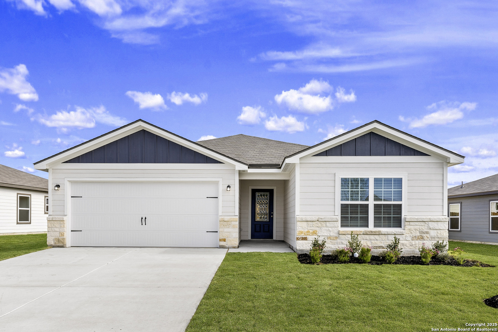 a front view of a house with a yard and garage