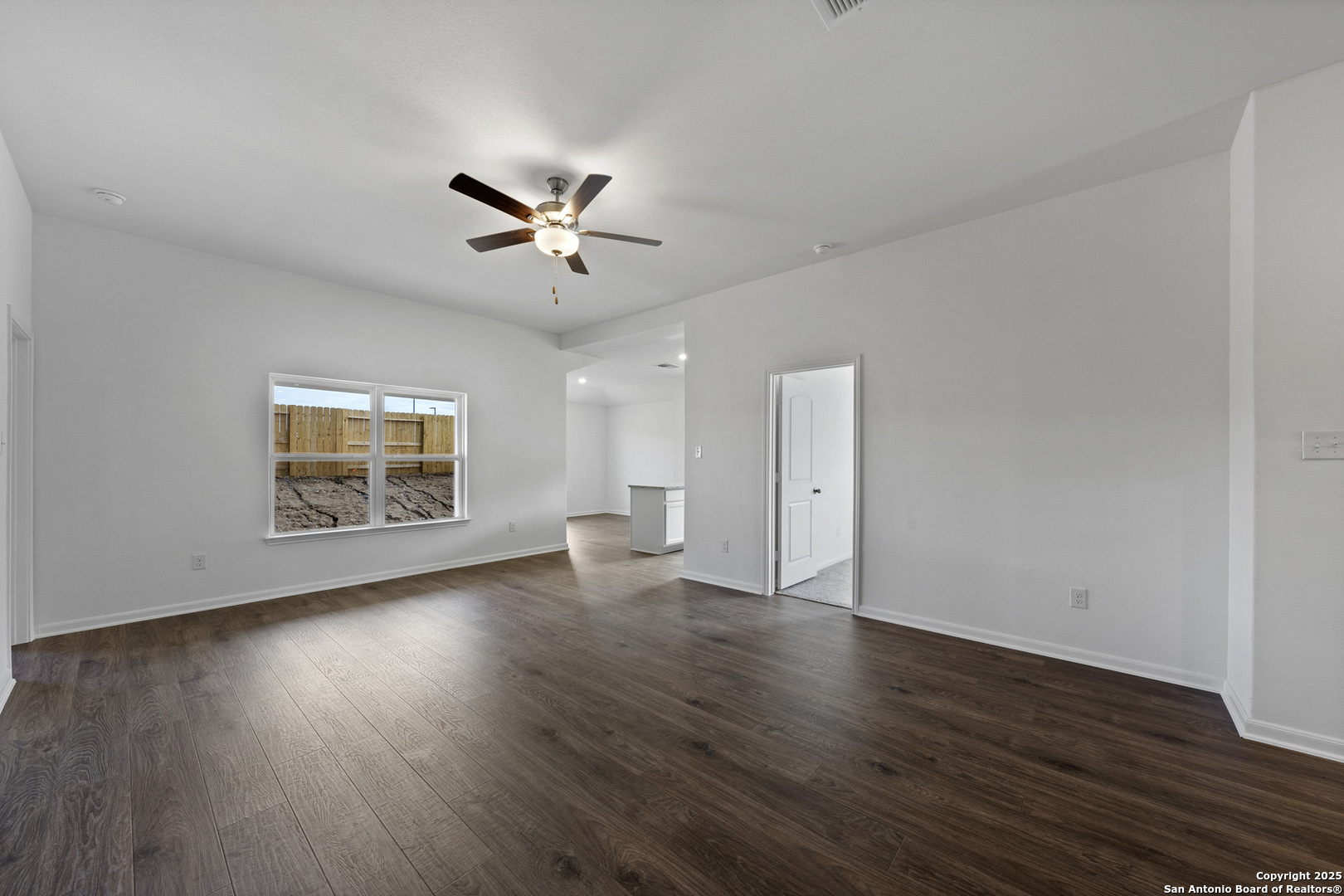 16021 Stratford Cove Lytle, TX 78052 - Photo 5 of 30 an empty room with wooden floor and windows
