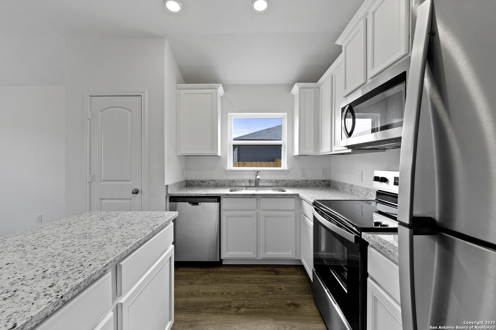 16021 Stratford Cove Lytle, TX 78052 - Photo 6 of 30 a kitchen with stainless steel appliances granite countertop a sink stove and refrigerator