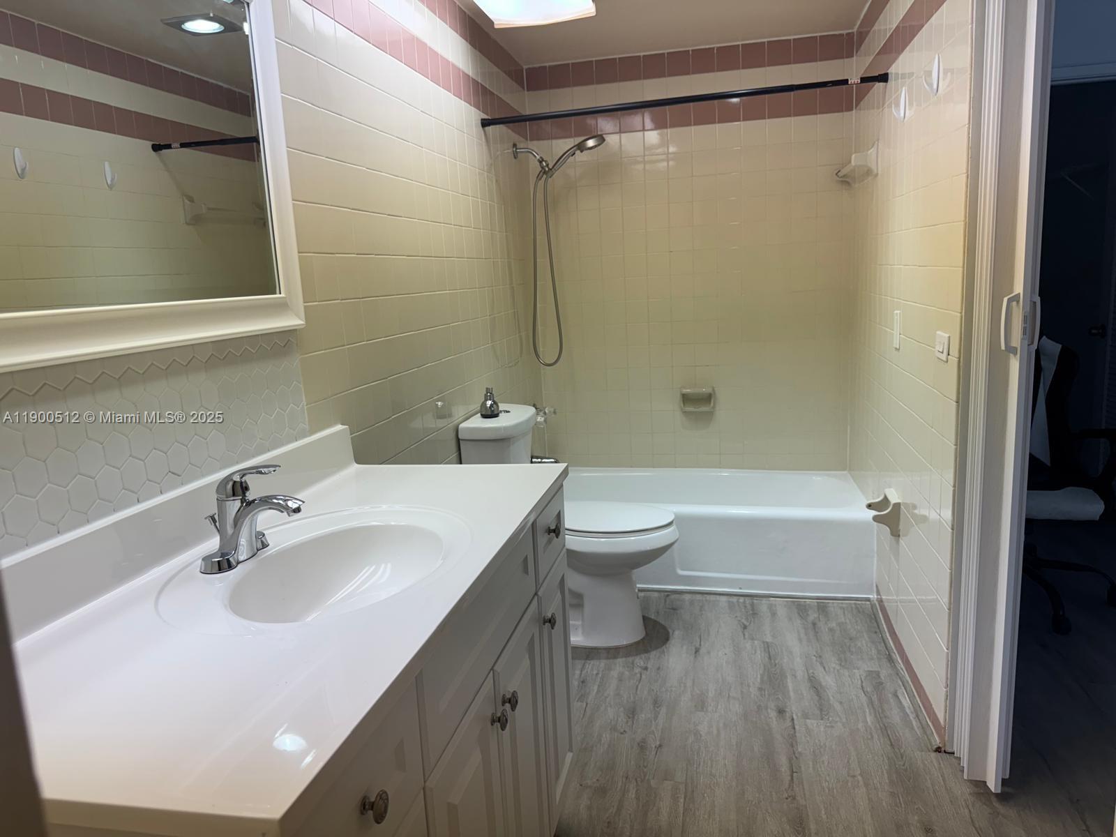 9155 Fontainebleau Boulevard, Unit 5 Miami, FL 33172 - Photo 13 of 18 a bathroom with a sink toilet and shower