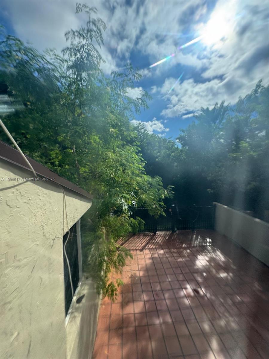 9155 Fontainebleau Boulevard, Unit 5 Miami, FL 33172 - Photo 14 of 18 a backyard of a house with lots of green space