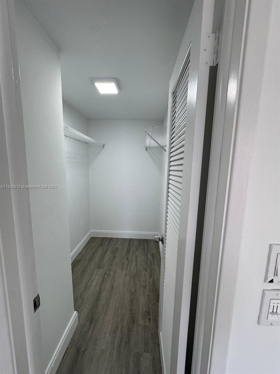9155 Fontainebleau Boulevard, Unit 5 Miami, FL 33172 - Photo 16 of 18 a view of a hallway with wooden floor