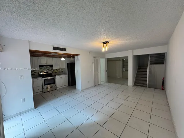 a view of kitchen with microwave and cabinets