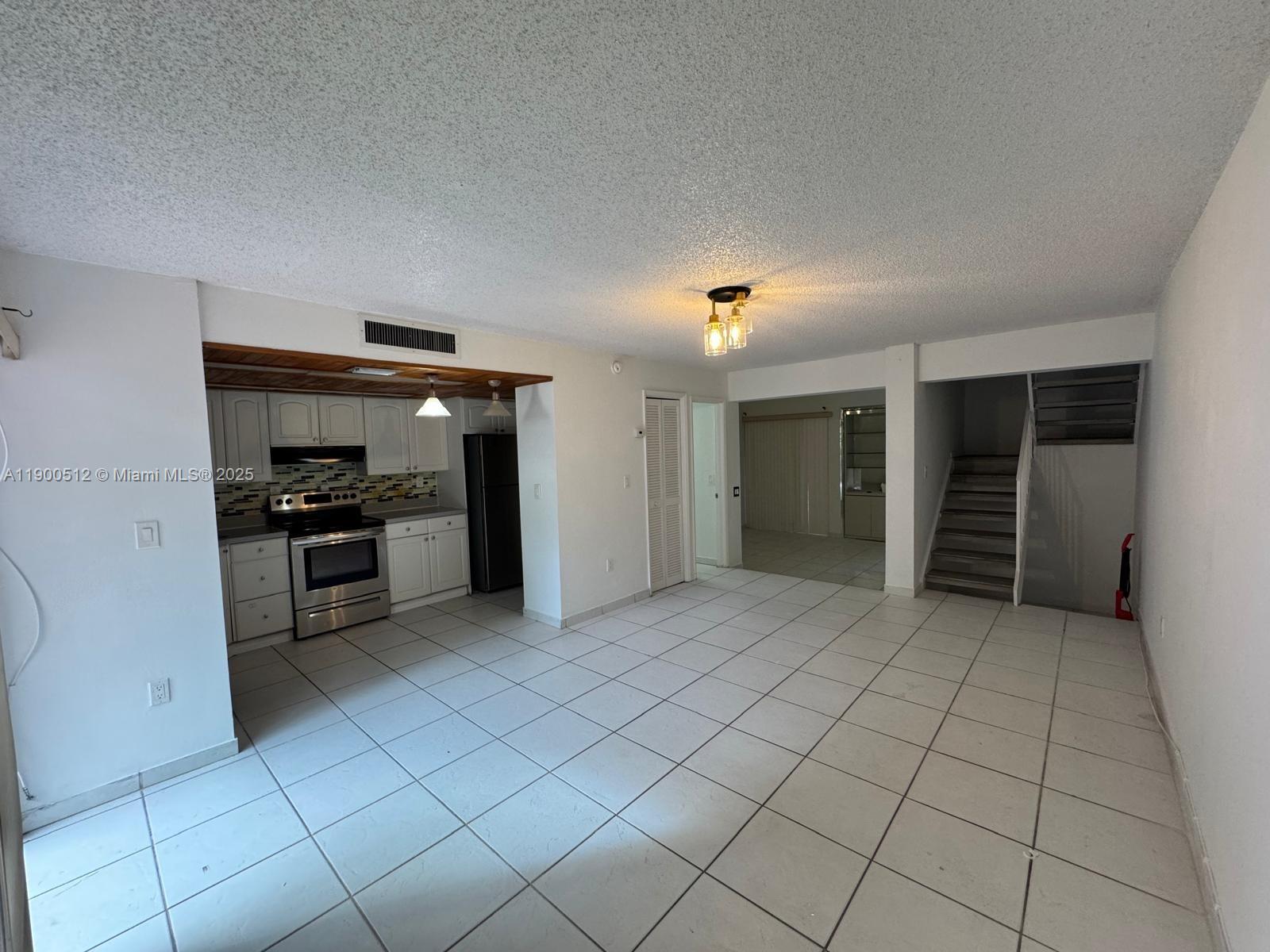 9155 Fontainebleau Boulevard, Unit 5 Miami, FL 33172 - Photo 3 of 18 a view of kitchen with microwave and cabinets