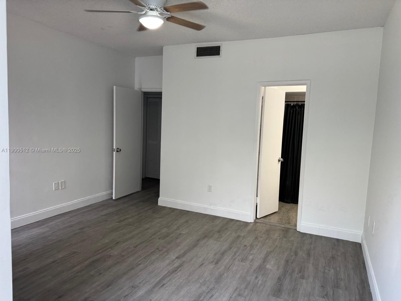 9155 Fontainebleau Boulevard, Unit 5 Miami, FL 33172 - Photo 10 of 18 an empty room with wooden floor and closet