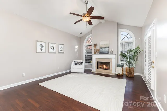a view of livingroom with furniture fireplace and fan