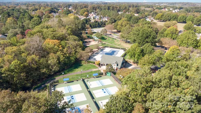 an aerial view of a house with a yard and lake view