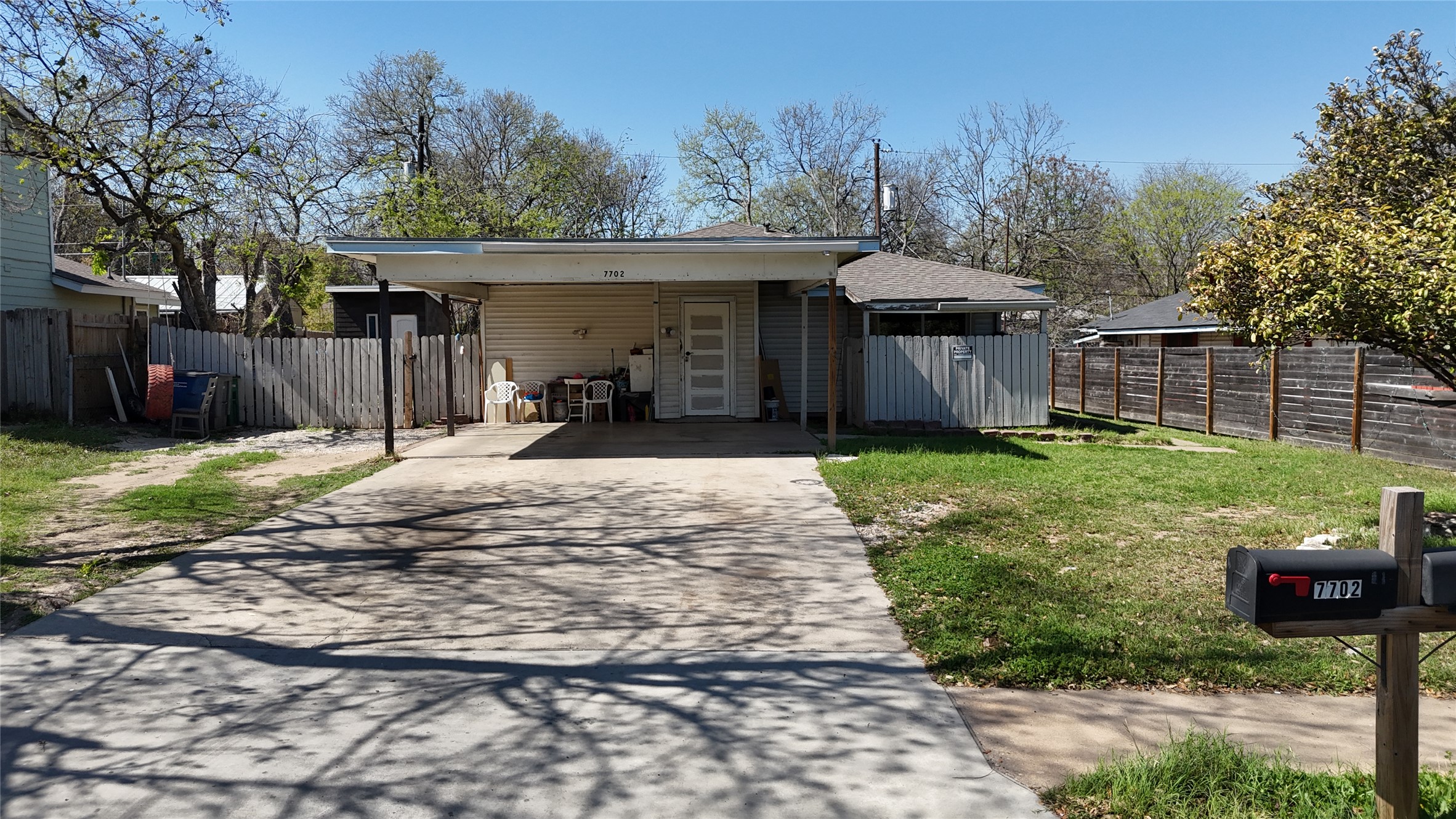 7702 Northcrest Boulevard Austin, TX 78752 - Photo 18 of 18 View of front of house with driveway and an attached carport