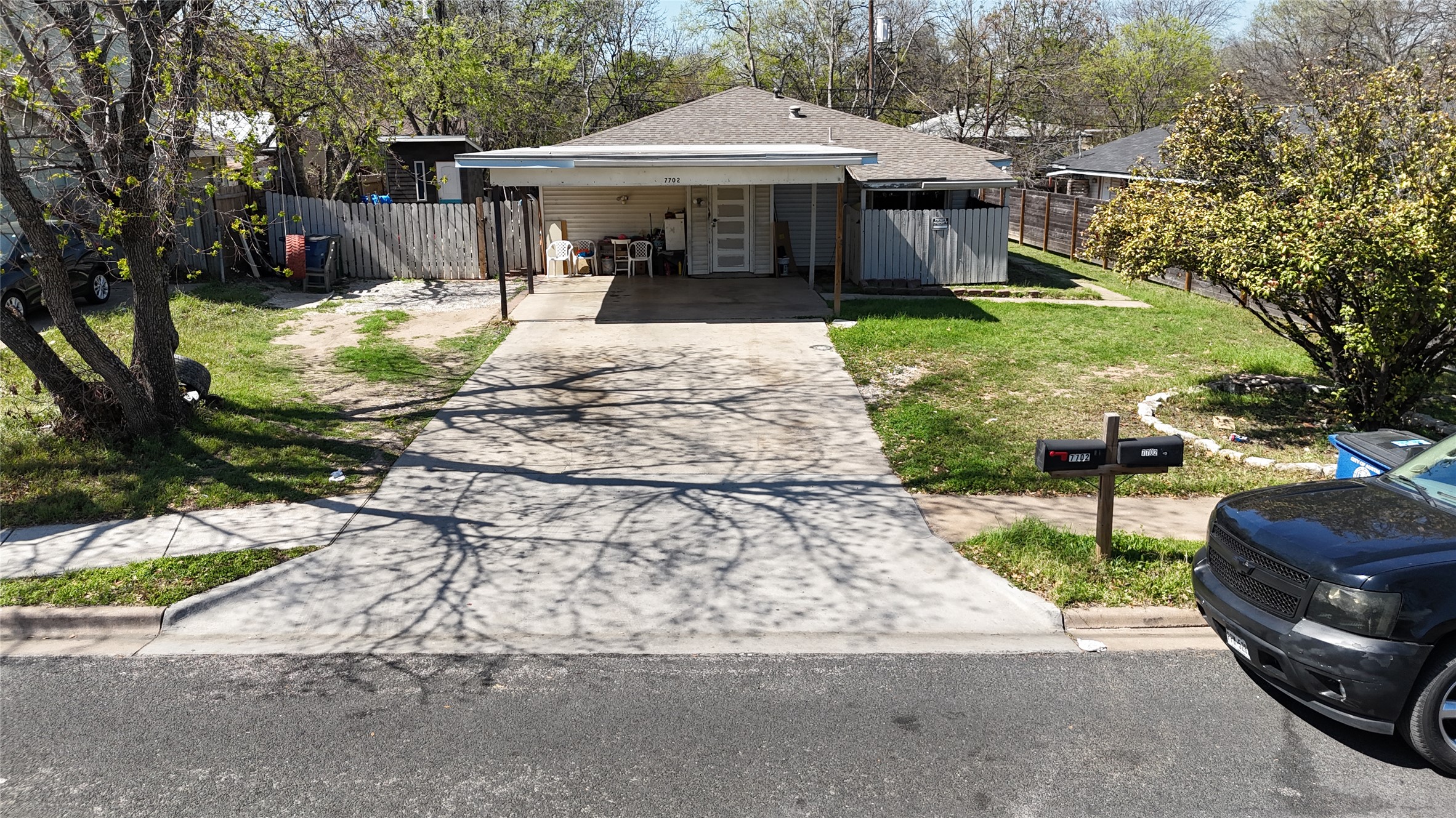 7702 Northcrest Boulevard Austin, TX 78752 - Photo 5 of 18 View of front of home featuring concrete driveway, an attached carport, and roof with shingles