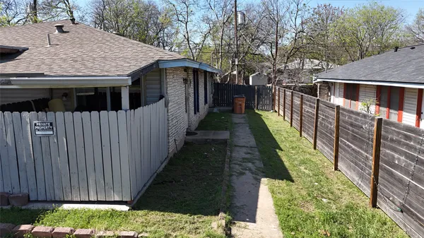 a view of a house with wooden fence