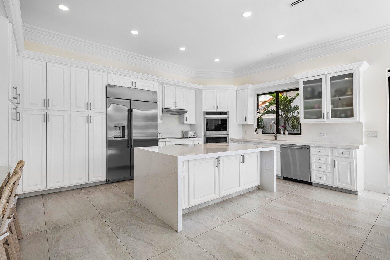 1536 Southwest 5th Avenue Boca Raton, FL 33432 - Photo 13 of 37 a kitchen with white cabinets and white appliances