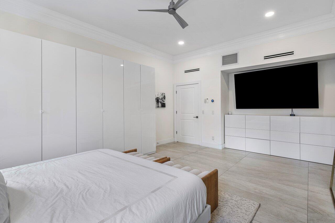 1536 Southwest 5th Avenue Boca Raton, FL 33432 - Photo 20 of 37 a bedroom with a bed and a flat screen tv