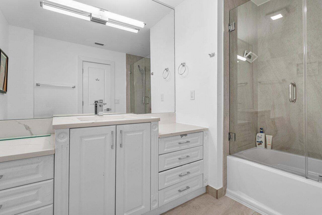 1536 Southwest 5th Avenue Boca Raton, FL 33432 - Photo 31 of 37 a bathroom with a bathtub sink vanity and mirror