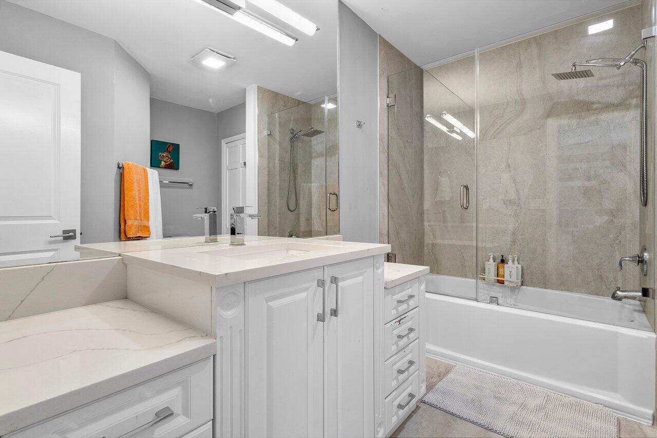 1536 Southwest 5th Avenue Boca Raton, FL 33432 - Photo 33 of 37 a bathroom with a granite countertop sink mirror and a bathtub