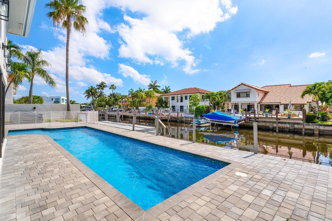 1536 Southwest 5th Avenue Boca Raton, FL 33432 - Photo 34 of 37 a view of swimming pool with outdoor seating and a garden