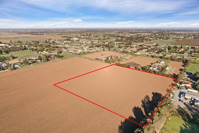 an aerial view of residential building and ocean view in back
