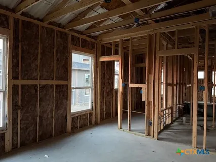a view of an empty room with wooden walls