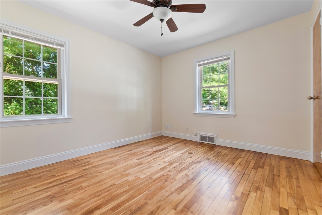 27 May Street Marblehead, MA 01945 - Photo 17 of 34 a view of an empty room with wooden floor and a window