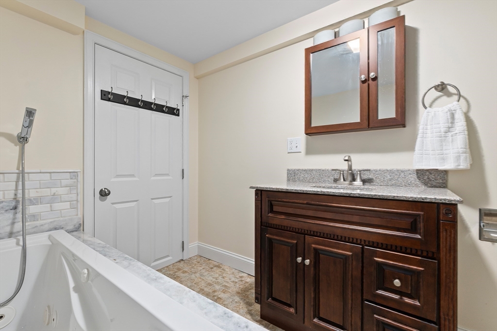 27 May Street Marblehead, MA 01945 - Photo 25 of 34 a bathroom with a sink a vanity and a mirror