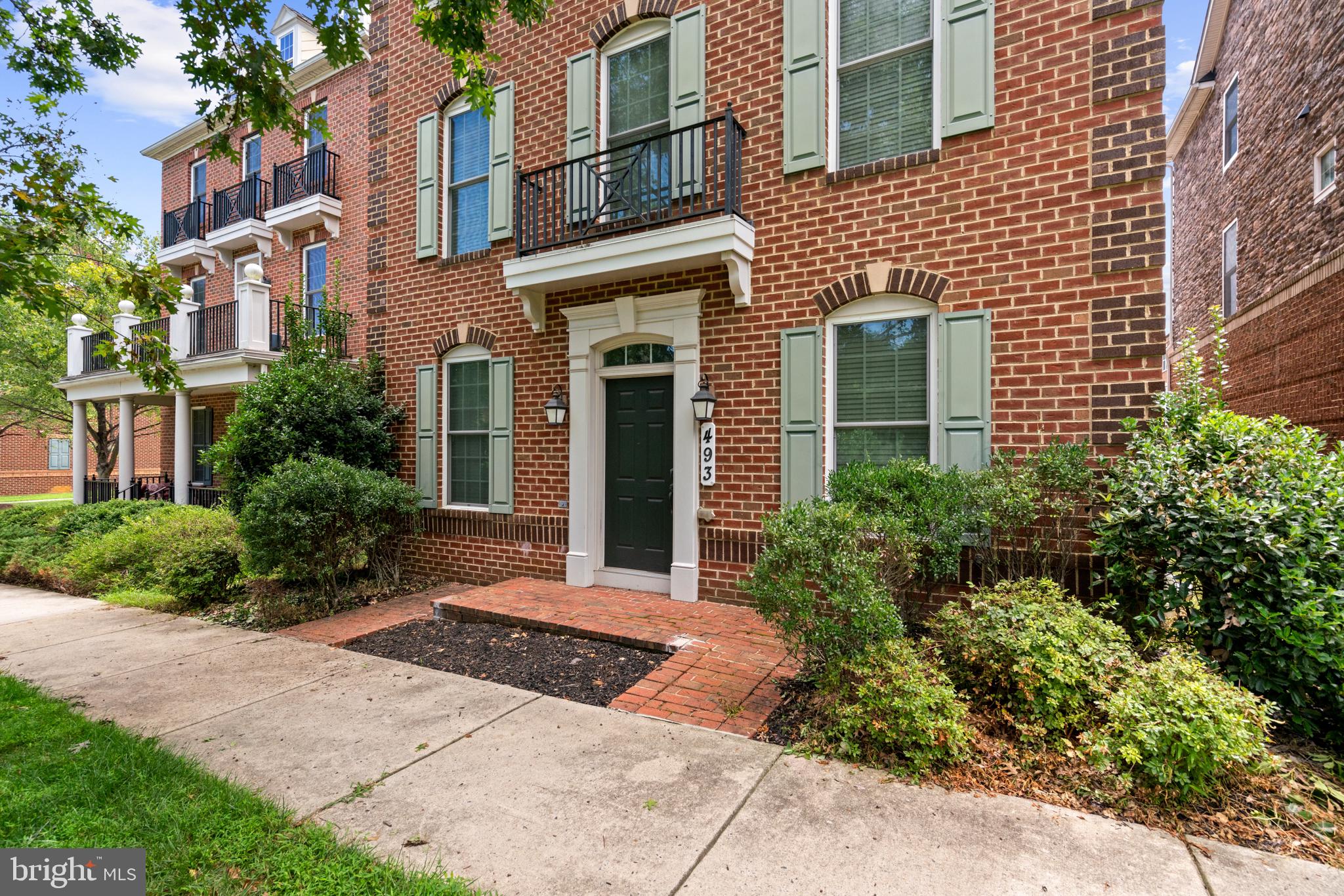 Charming brick facade with lush greenery.