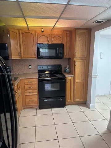 a kitchen with stainless steel appliances granite countertop a refrigerator and a stove
